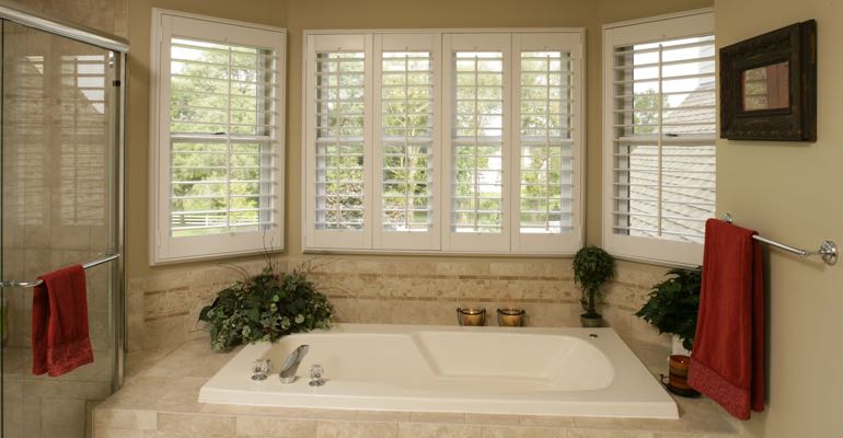 Plantation shutters in New York bathroom.